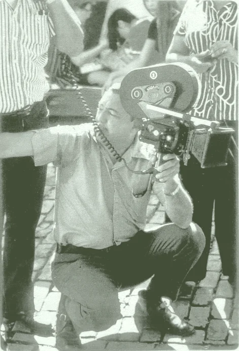 Juan E. Viguié Jr. operating a camera on location